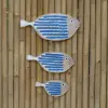 Product image 1 of the product “Fish shape to hang (abstract), made of wood, set of 3 in different blue colors. Size L: 50x22x3cm H, Size M:40x18x3cm H, Size S: 29x14x3cm H. ”